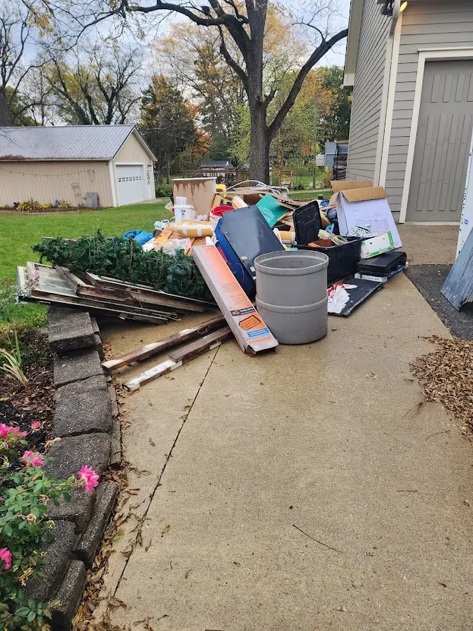 Dumpster being loaded with debris for Roofing Dumpster Rental in Woodruff